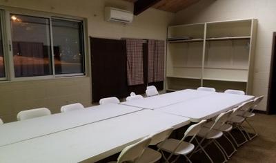 Meeting room with a long white table and chairs