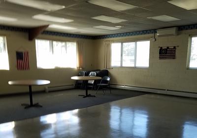 round tables in a conference room surrounded by windows